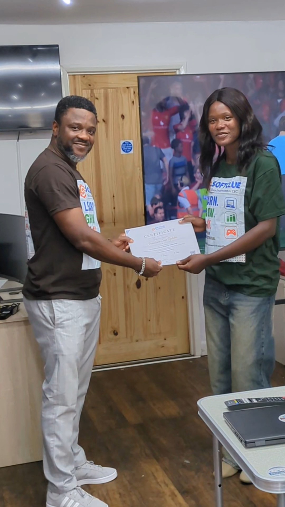 Graduate receiving her certificate with a handshake