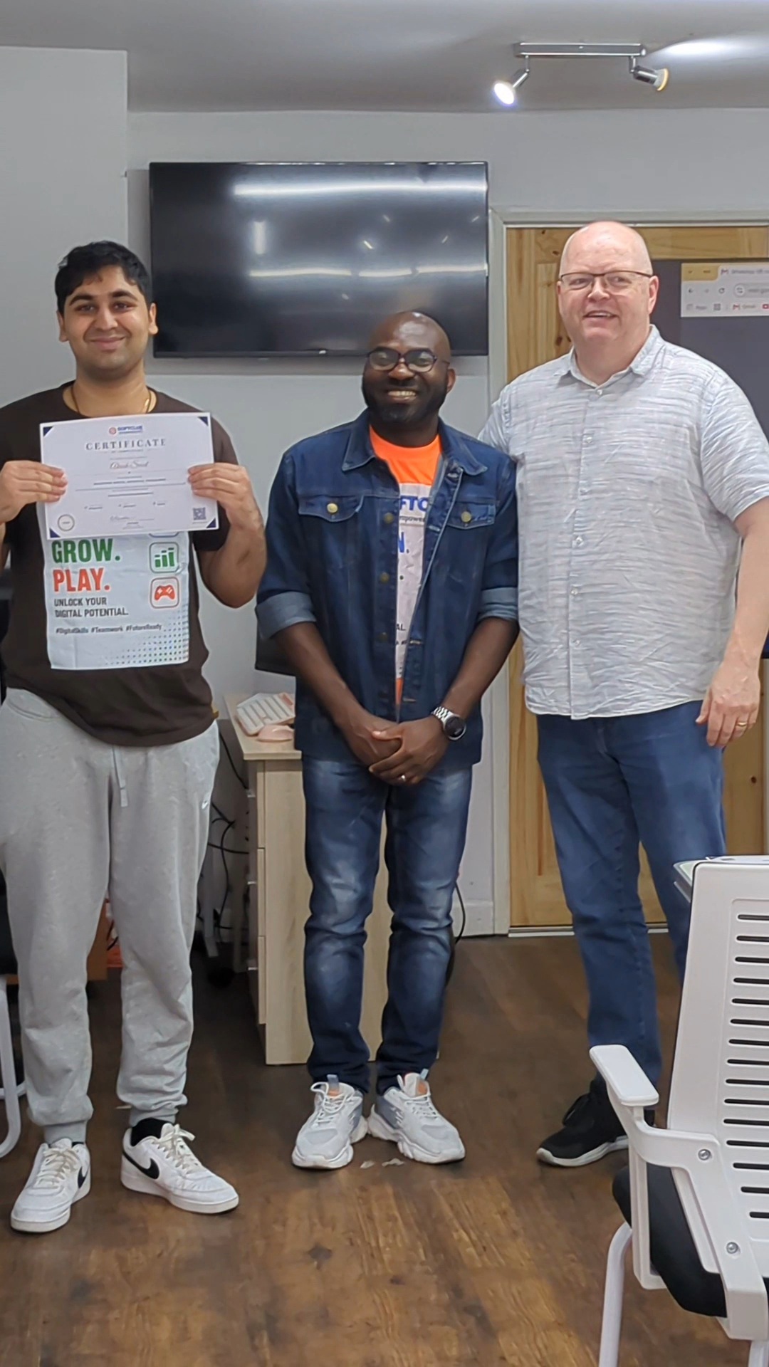 Graduate showing off his certificate in The POD