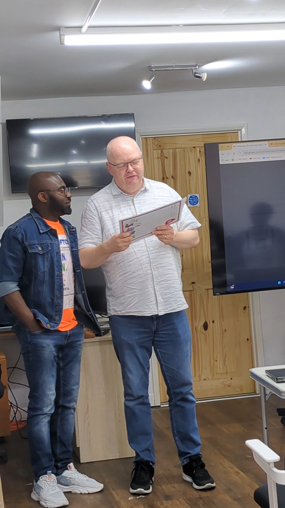 A graduate reading their certificate for the first time
