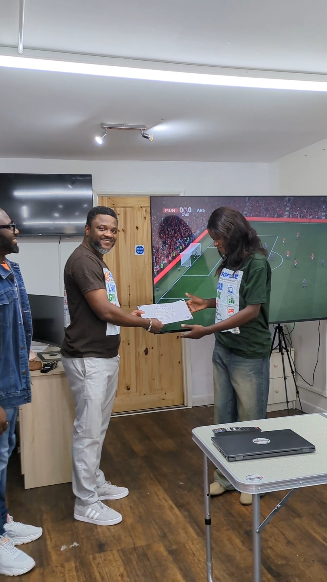 Certificate handover in front of the big screen at The POD