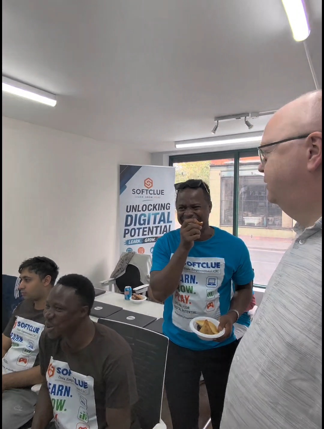 Learner celebrating with food at the graduation gathering